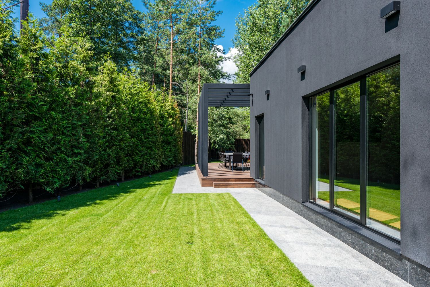 Modern home exterior with outdoor wall lighting; illustrative stock photography